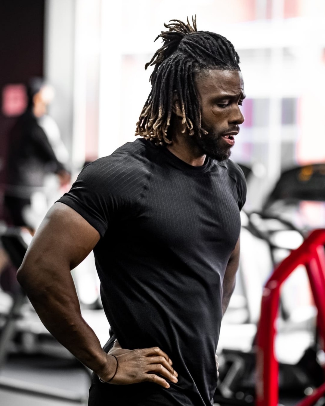 A trainer in the gym, hands on hips